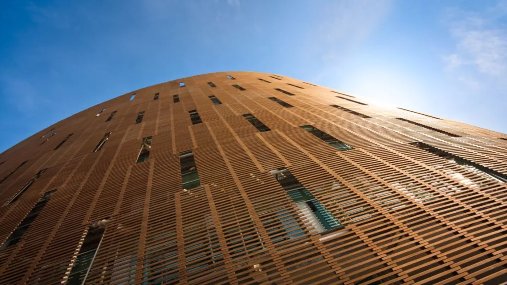 A building featuring wooden slats set against a clear blue sky.